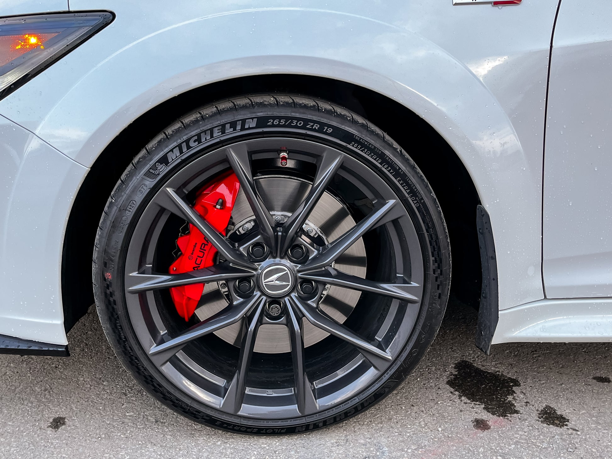 car wheel with a Michelin tire on a white vehicle.
